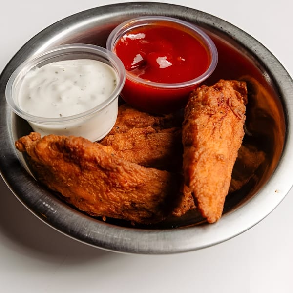 Tipsea's fried chicken tenders with ranch and ketchup in a metal bowl.